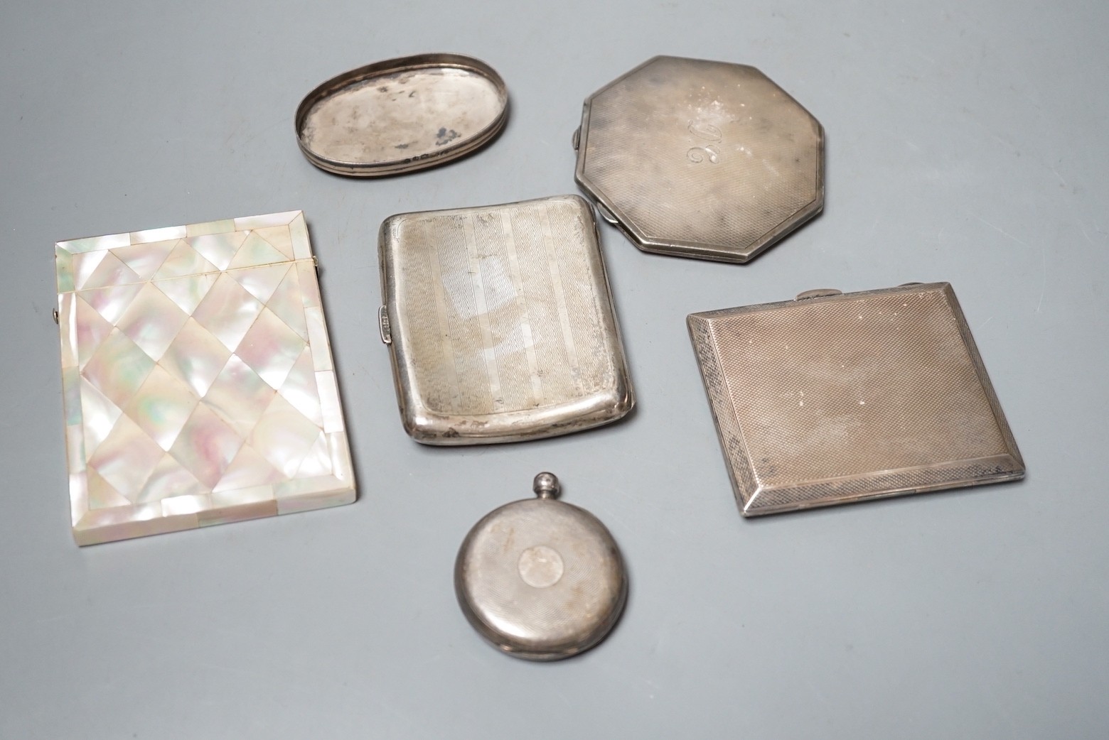 A 1920's silver and enamelled cigarette case, a 1930's silver and enamelled compact, a silver cigarette case, silver lid, silver pocket watch and a mother of pearl card case.
